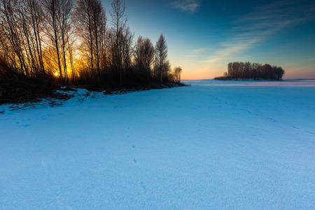 Beautiful cold morning on snowy winter countryside. Polish countryside at snowy winter.の写真素材