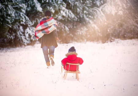 Small boy playing outdoor in snowy winter landscape.の写真素材