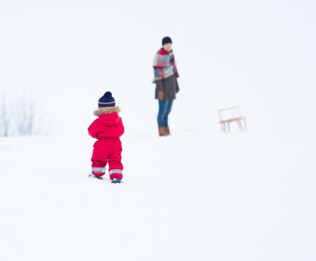 Small boy playing outdoor in snowy winter landscape.の写真素材