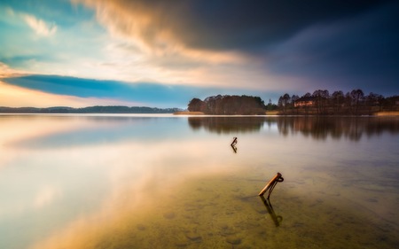 Long exposure lake landscape photographed at sunset. Lake Krzywe in Olsztyn, Mazury lake districtの写真素材