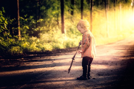 Caucasian boy playing outdoor at summer day. Natural childhood photoの写真素材