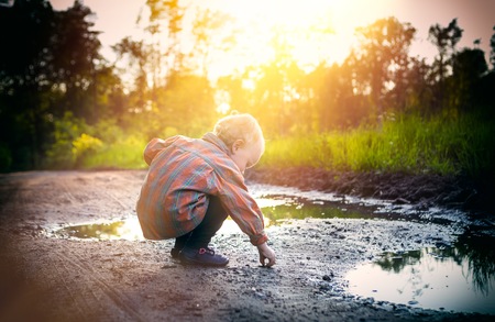 Caucasian boy playing outdoor at summer day. Natural childhood photoの写真素材
