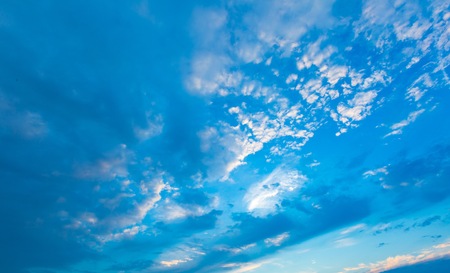 Abstract background of sunset blue sky with clouds illuminated by sun.の写真素材