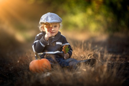 Boy playing outdoor in autumn or spring scenery.の写真素材