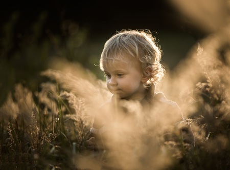 Boy playing outdoor in autumn or spring scenery.の写真素材