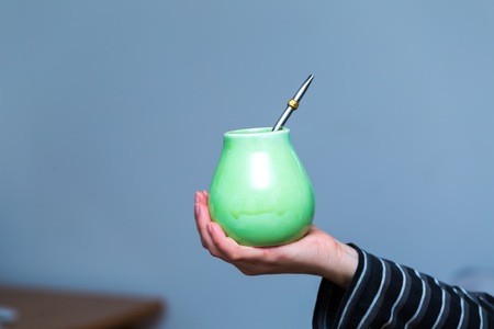 Unrecognizable woman drinking yerba mate from ceramic cup.の写真素材