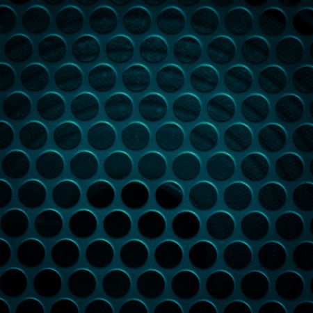 Dark grid background. Close up of aluminum speaker. Texture with holes.の写真素材
