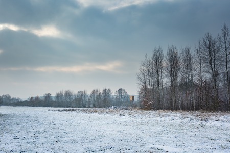 Winter landscape with snow covered countryside and raised hide. European winter landscape.の写真素材