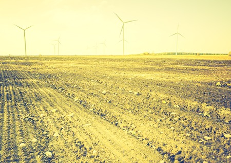 Vintage photo of field with windmills. Polish autumn landscape with filtered look.の写真素材