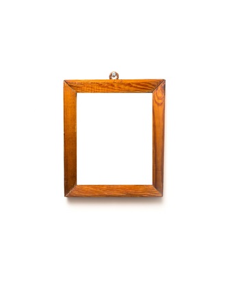 Old wooden frame of pine wood hanging on white wall background. Wooden frame on white wall.