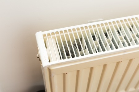 Close up of home heater. Home radiator hanging on wall in close up.の写真素材