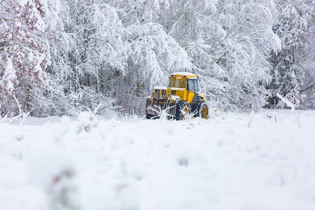 Snow plow on winter road. Winter landscape with machine (snow plow at work)の写真素材