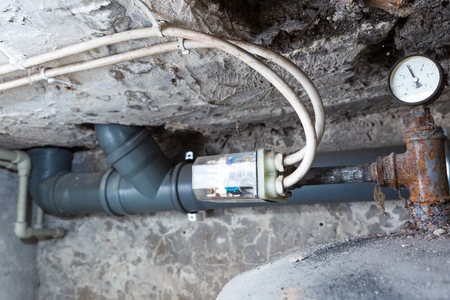 Electronic controller of water tank in home basement. Close up of electronic equipment.
