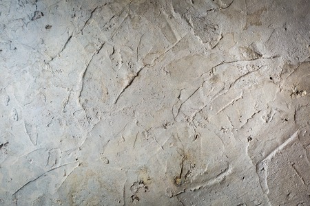 Old destroyed concrete wall with uneven structure. Color wall background.の写真素材