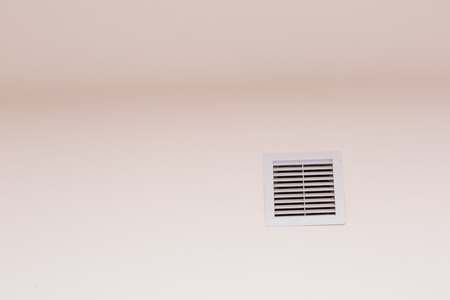Close up of vent on the white wall. Plastic ventilation grid, piece of home ventilation system.の写真素材