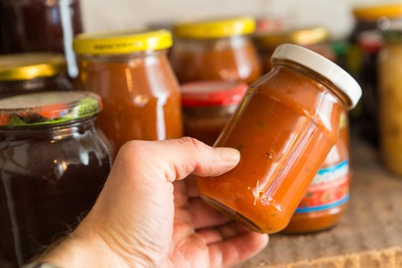 Preserves in jars in home basement. Close up of stocks kept for the winter.の写真素材