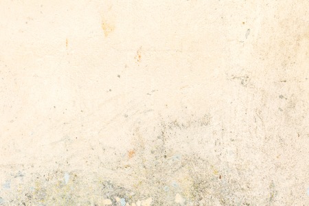 Old wall yellow background. Close up of wall texture. Stained and scratched wall.の写真素材