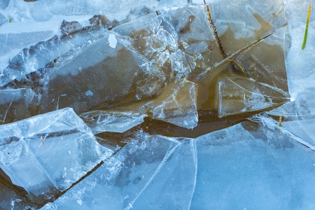 Ice on water texture> Cracked texture. Close up of winter frozen water surface.の写真素材