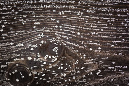 Dark old wood with hoarfrost. Old wooden background with winter cold ice.の写真素材