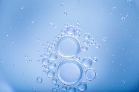 Oil droplets on water surface. Abstract background with shallow depth of field. Liquid abstract.
