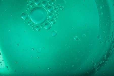 Oil droplets on water surface. Abstract background with shallow depth of field. Liquid abstract.
