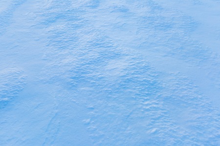 Beautiful snow background. Snow photographed at sunset. Natural winter sceneryの写真素材