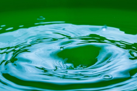 Close up of splashing droplet and water surface. Abstract background.の写真素材