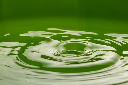 Close up of splashing droplet and water surface. Abstract background.の写真素材