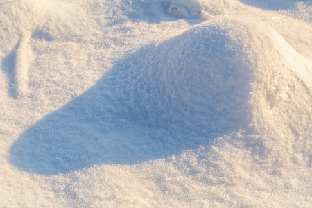 Snow background in close up. Surface of fresh winter snow in sunset ligh.の写真素材