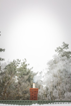 House chimney on roof in winter. Close up of roof with chimney.の写真素材