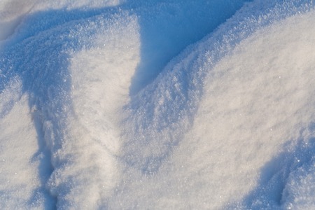 Snow background in close up. Surface of fresh winter snow in sunset ligh.の写真素材
