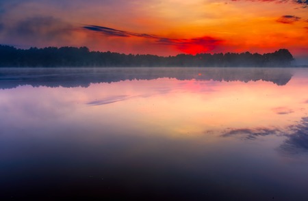 Sunrise over foggy lake in Poland. Beautiful summer landscape.の写真素材