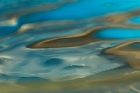 Abstract macro of moving waves on luquid. Water surface macro.