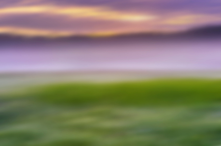 Blurred abstract landscape of sunrise over summer meadow. Defocused abstractionの写真素材