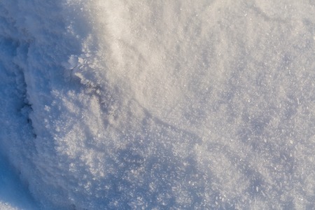 Snow background in close up. Surface of fresh winter snow in sunset ligh.の写真素材