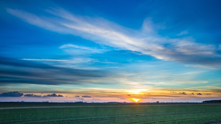 Beautiful vibrant sky over fields in Poland. Horizon and sky over fields.の写真素材