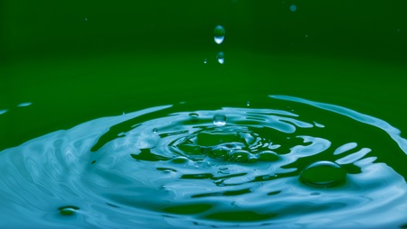 Close up of splashing droplet and water surface. Abstract background.の写真素材