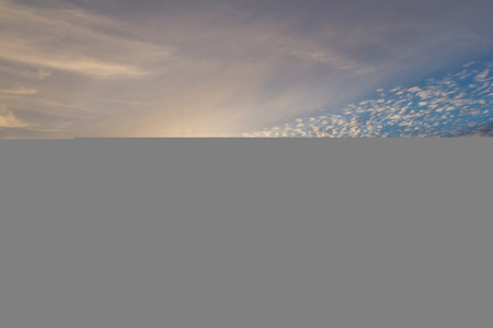 Beautiful colorful sunset sky over plowed field in springtime. Calm polish landscape. Countryside...