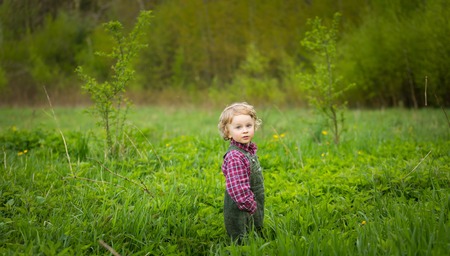 Handsome caucasian young baby boy playing outdoor in spring. Caucasian boy in outdoor.の写真素材