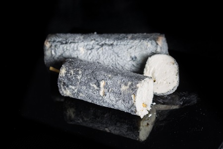 Studio shot of french goat cheese Saint Maure. Luxury food.の写真素材