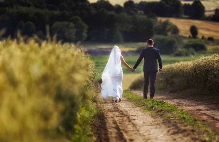 Wedding couple in outdoor. Beautiful young woman and man in outdoor in their wedding session.の写真素材