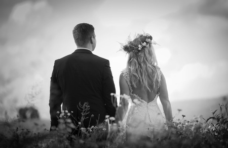Wedding couple in outdoor. Beautiful young woman and man in outdoor in their wedding session.の写真素材