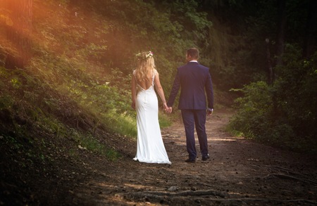Wedding couple in outdoor. Beautiful young woman and man in outdoor in their wedding session.の写真素材