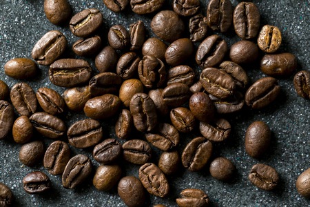 Coffee beans in close up lying on dark background. Coffee background.の写真素材