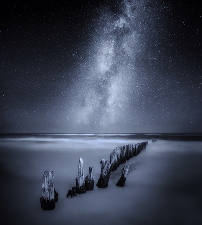 Sea night landscape with Milky Way over old wooden  pier. Fine art landscape.の写真素材