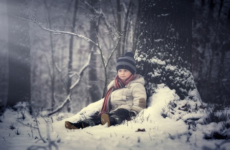 Happy young boy playing in snow. Winter landscape with happy boy.の写真素材