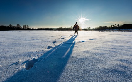 Man silhouette in tranquil winter landscape. Surreal landscape with human,の写真素材