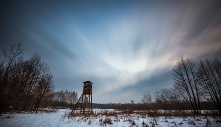 Winter landscape photographed with long exposure. Natural wild landscape with raised hide.の写真素材