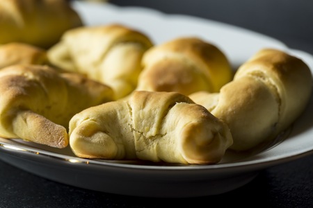 Fresh baked yeast croissants on dark background. Tasty homemade cakes.の写真素材