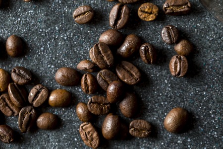 Coffee beans in close up lying on dark background. Coffee background.の写真素材